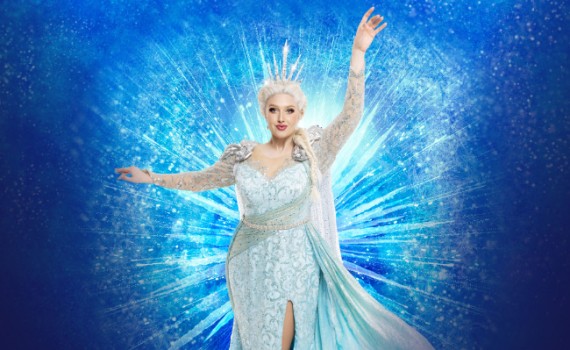 Elsa seen poised with magical power, wearing a beautiful gown.
